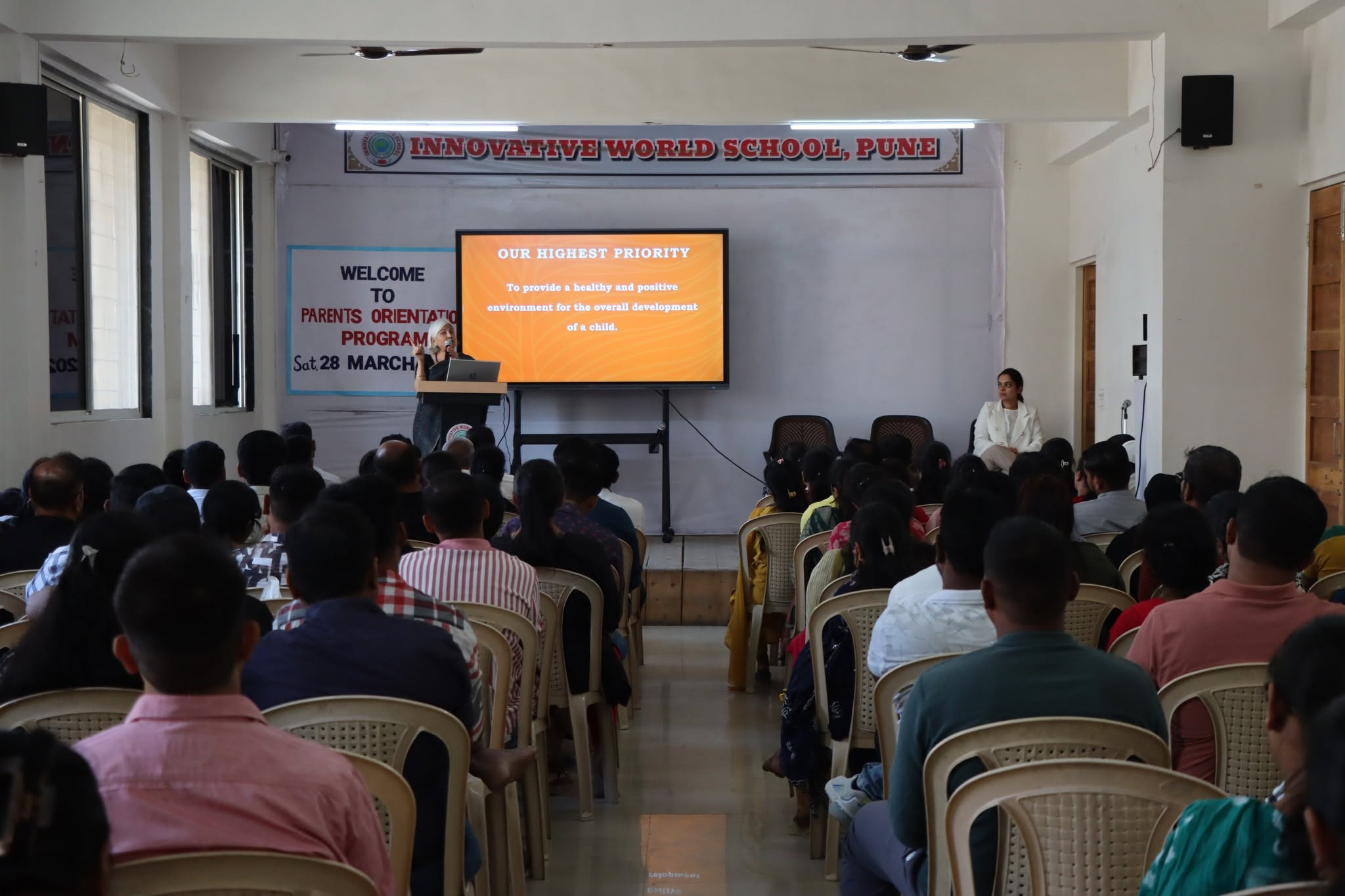 Teacher addressing parents at Innovative World School PTM