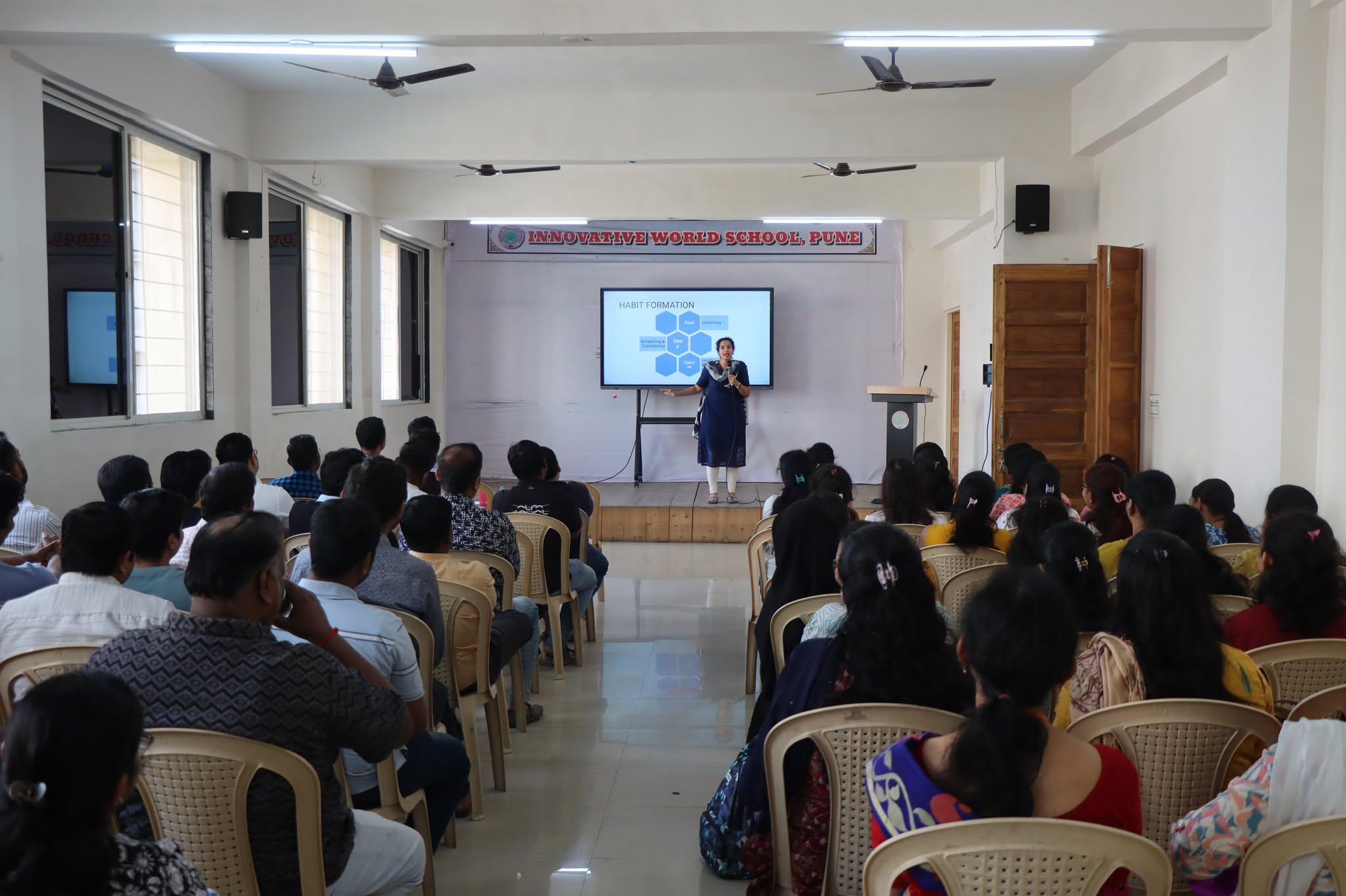Teacher presenting academic updates at Innovative World School
